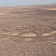 Illustration for article titled Who created these huge, mysterious wheel patterns in the Mideast thousands of years ago?